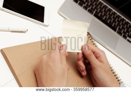 An Office Worker Holds An Empty Sticker With His Hands. Empty Space For The Text.