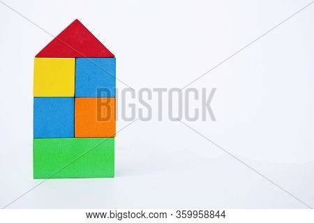 Toy House On A White Background. A House Made Of Color Bricks. With Space For Writing