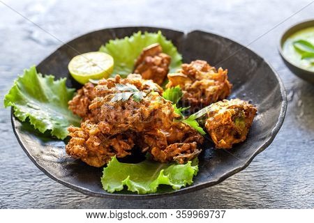 Indian Cuisine Indian Food. Pakora Traditional Indian Deep-fried Snack. Pakoras On Black Plate With 
