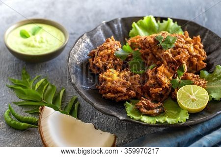 Indian Cuisine Indian Food. Pakora Traditional Indian Deep-fried Snack. Pakoras On Black Plate With 