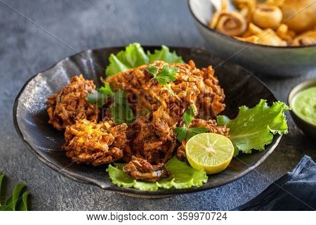 Indian Cuisine Indian Food. Pakora Traditional Indian Deep-fried Snack. Pakoras On Black Plate With 