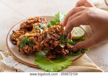 Indian Cuisine Indian Food. Pakora With Coconut Chutney Sauce Curry Leaves. Hand Of Young Indian Wom