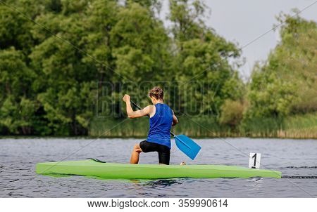 Canoe Single Men Paddles On Lake In Canoeing Sprint