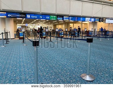 Orlando,fl/usa-3/21/20:  People Going Through Orlando International Airport Mco Tsa Security On A Sl