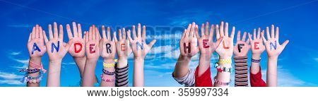 Kids Hands Holding Word Anderen Helfen Means Help Others, Blue Sky