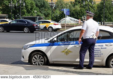 Moscow, Russia - July 2022: Traffic Police Officer Standing On The Road Near His Car In Summer. Poli
