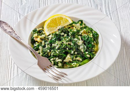 Spanakorizo, Greek Spinach And Rice Pilaf With Lemon, Dill, Spring Onion In White Bowl With Fork On 