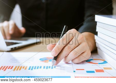 Businessman Analyzing Financial Balance Sheet And Corporate Profit Report Graph At Office, Calculati