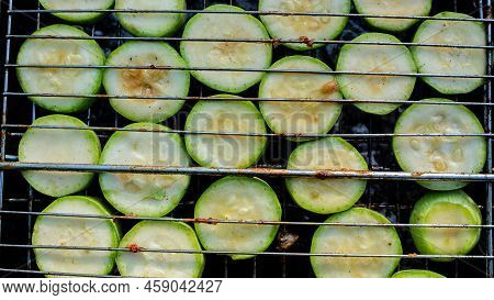 Cooking Courgettes On The Grill. Green Courgettes Are Fried At A Barbecue