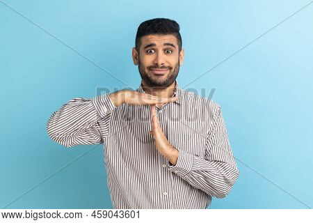 Timeout. Portrait Of Young Handsome Businessman Standing With Serious Face And Looking At Camera Wit