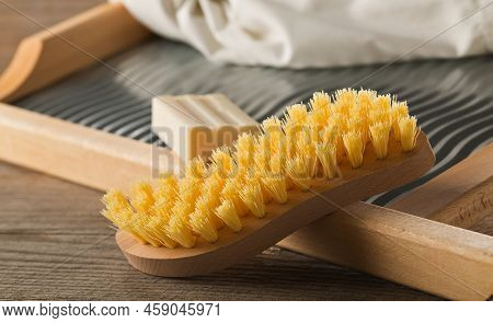 Close Up Of Wood And Metal Washboard Or Wash Board With Brush, Piece Of Washing Soap Bar And White S