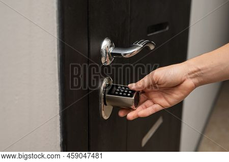 Woman Opens The Combination Lock On The Door To The Apartment. Keyless Entry.