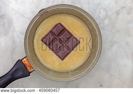 Bain-marie With Honey Batter And Chocolate On Saucepan
