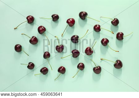 Closeup Top View On Fresh Red Cherries Pattern On Aqua Blue Background