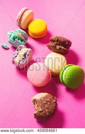 Bright Colorful Various Flavor Macarons Sweet Cookies On High-colored Pink Background.