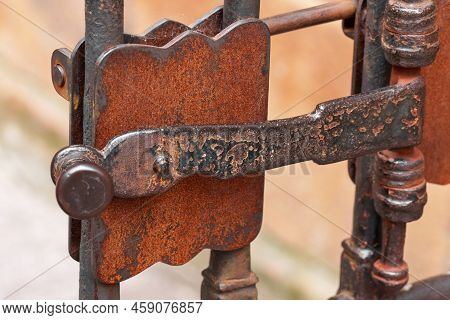 Ancient Metal Rusty Wrought Handle Deadbolt (latch) Of Closed Door Of The Lattice Gate Of The Antiqu