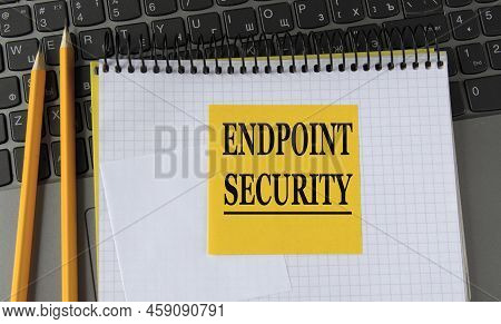 Endpoint Security - Words On A Yellow Piece Of Paper On The Background Of A Laptop With A Notebook A