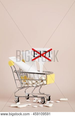 Titanium Dioxide, E171, Dangerous Additive Concept. Gum, Pills, Toothpaste, Cream In Basket And Sign