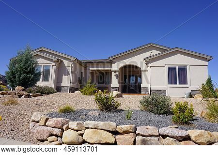 Stucco House In The Desert With Xeriscape Landscaping.