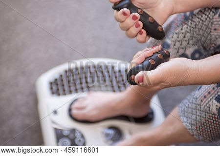 Massager For Myostimulation Of Feet And Hands Close-up. Treatment And Rehabilitation. Modern Technol