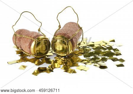 Corks Of Sparkling Wine With Muselet Caps And Shiny Golden Confetti On White Background