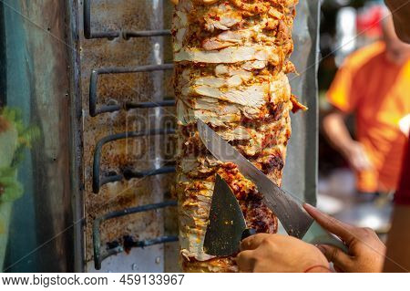 Chef Cutting With Doner Knife Traditional Turkish Doner Kebab Meat.
