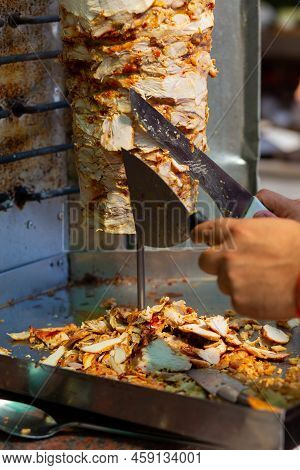 Chef Cutting With Doner Knife Traditional Turkish Doner Kebab Meat.