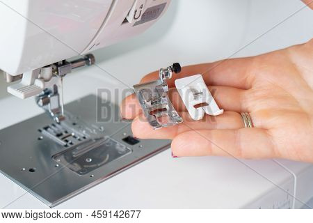 Seamstress Holds Sewing Machine Parts In Hands. Presser Foot Accessories In Tailor Hand. Dressmaker 