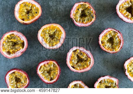 Halves Of Juicy Sweet And Sour Passion Fruit On A Gray Background. Passion Fruit Pattern. Exotic Asi
