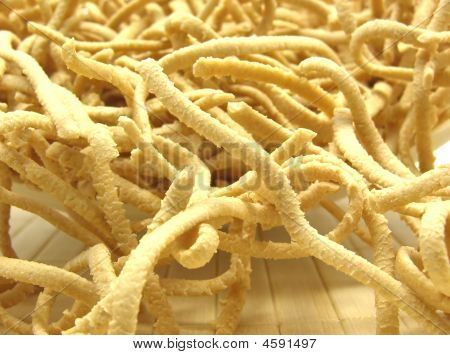 A Close Up View At Uncooked Wholemeal Spaetzle On A Placemat