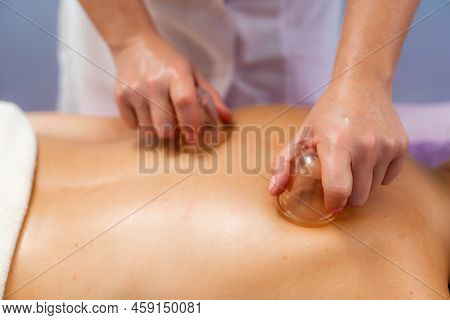 Facial Massage. A Woman Is Given A Massage In A Beauty Salon. Close-up.