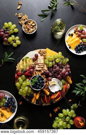 Autumn Cheese Board With Fresh Fruits, Nuts And Berries Served With White Wine, Top View