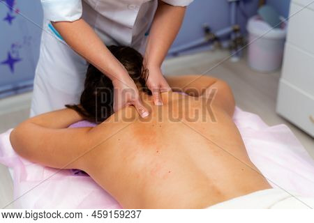 Facial Massage. A Woman Is Given A Massage In A Beauty Salon. Close-up.