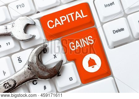Hand Writing Sign Capital Gains. Word Written On Bonds Shares Stocks Profit Income Tax Investment Fu