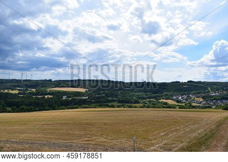Harvested Fields With A Small Town In The Valley