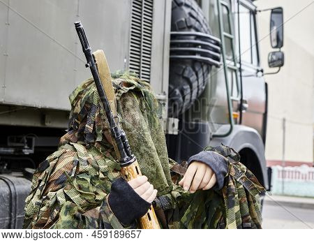 Close-up Portrait Of A Military Sniper In Camouflage Green Army Clothes With A Degtyarev Sniper Rifl