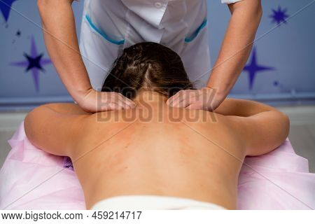 Facial Massage. A Woman Is Given A Massage In A Beauty Salon. Close-up.
