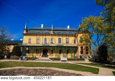Slatinany, Czech Republic, 17 April 2022: Classical Chateau Or Romantic Yellow Castle Surrounded By 