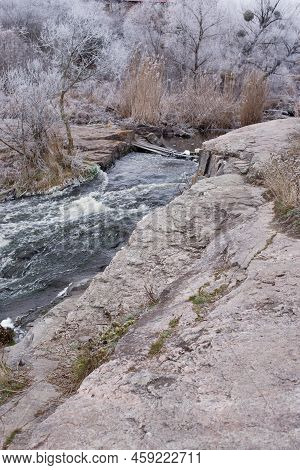 Beautiful Winter Landscape With Girskiy Tikych River Running Through Frosted Trees And Rocks.