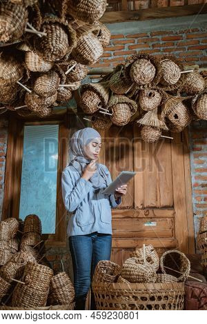 Female Entrepreneur In Hijab Thinking While Using Tablet