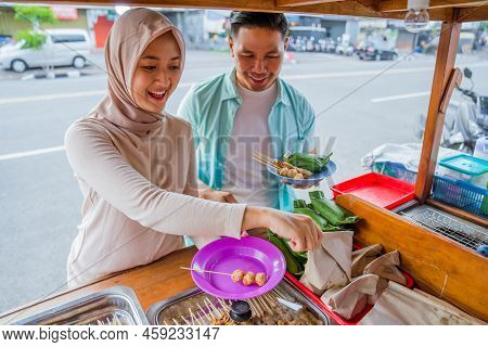 Couple Picking Some Snack And Food At Traditional Street Food Stall