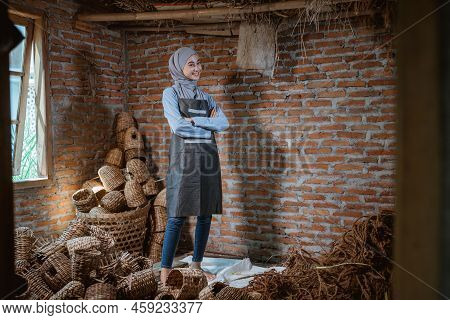 Craftswoman In Veil Standing Among Woven Water Hyacinth Crafts