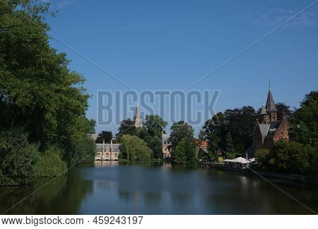 Minnewater Gothic Castle At The Lake Of Love In Bruges, Belgium, Bright Sunny Day, Beautiful Natural