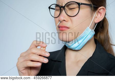 Young Asian Woman Using Rapid Antigen Test Kit By Nasal Swab Herself For Takes A Sample Of Cells Fro