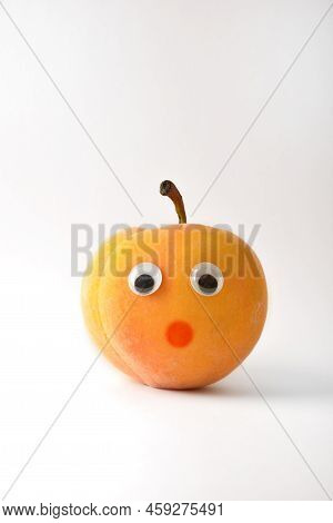 Healthy Peach With Face On White Isolated Background. Fruits And Vegetables Child Healthy Eating Con