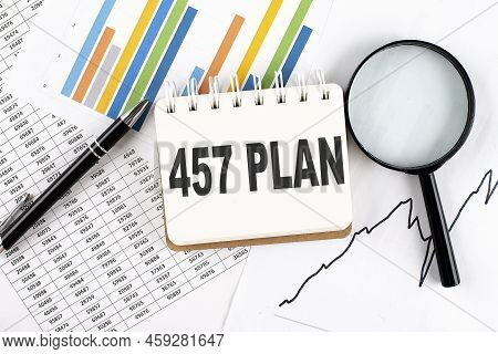 457 Plan Text On A Notebook On The Graph Background With Pen And Magnifier