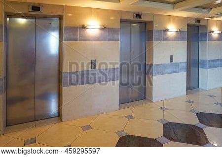 Three Elevator Doors In Office Building. Wide Angle View Of Modern Elevators With Doors. Elevators I