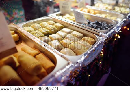 Hot Food On Krakow Christmas Market. Gabbage Rolls, Pancakes And Other Semi-finished Products . Trad