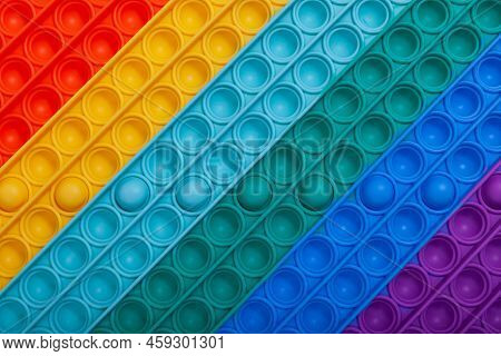 Surface Of Multi-colored Rubber Children's Toy Pop It, Close-up. Tap On Bubble, Finger Game. Top Vie