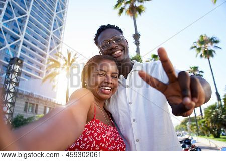 Selfie Of A Young Black Couple Looking At Camera Smiling. Concept Of Vacation And Relationship. Afri